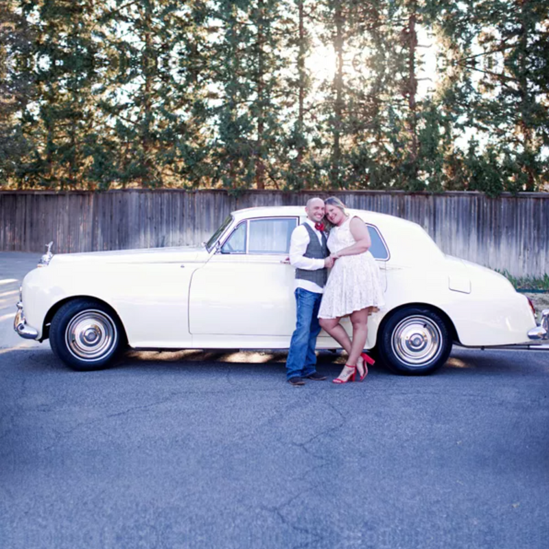 Couple standing next to 1963 Rolls Royce Silver Cloud