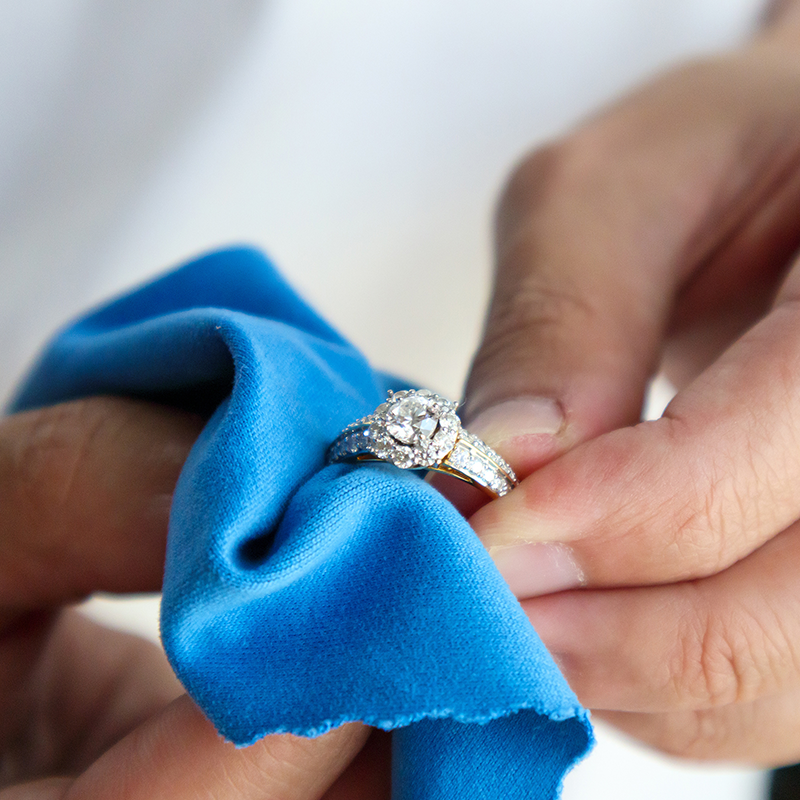 Wiping diamond ring with cleaning cloth