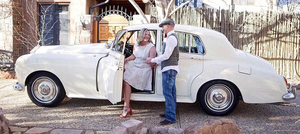 Photo of couple standing next to side of car